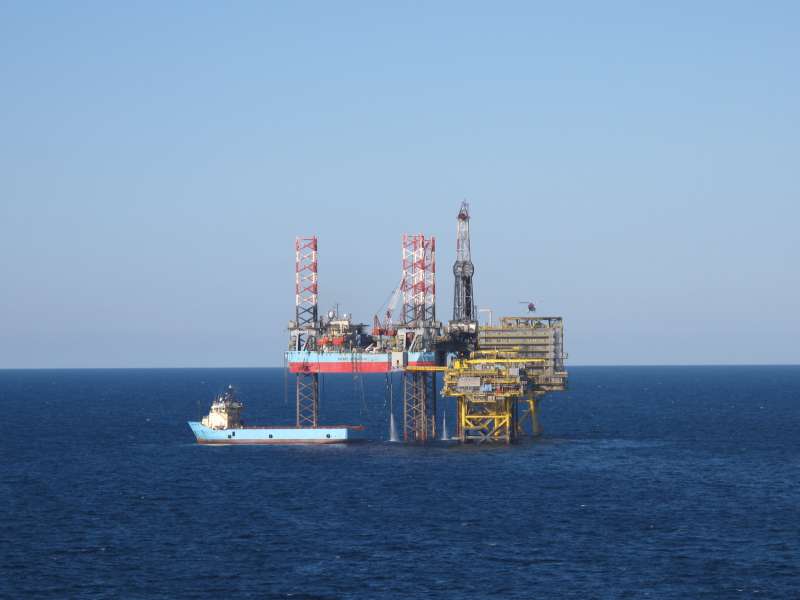 Offshore support vessel at sea at dusk with satellite domes on deck