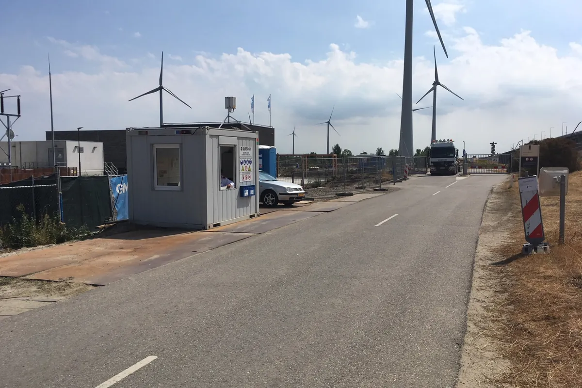 Site cabin with barrier and communication equipment at the entrance gate of a project location